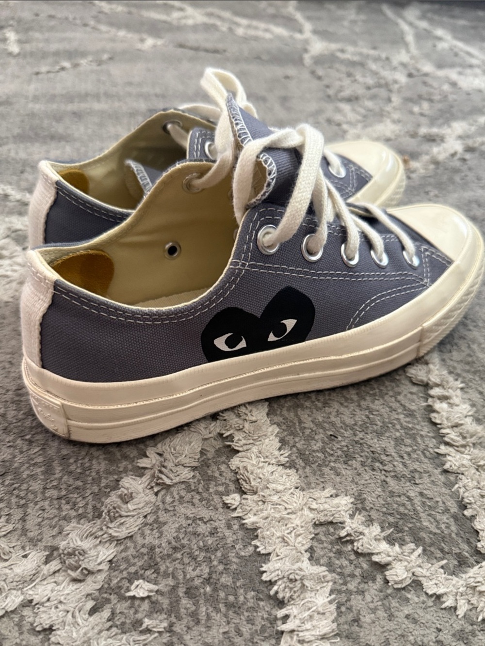 Comme des Garcons PLAY Gray Low-Top Canvas Sneakers.
